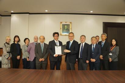 A group of SAF and Takushoky University offiicals in Japan stand together for a group photo