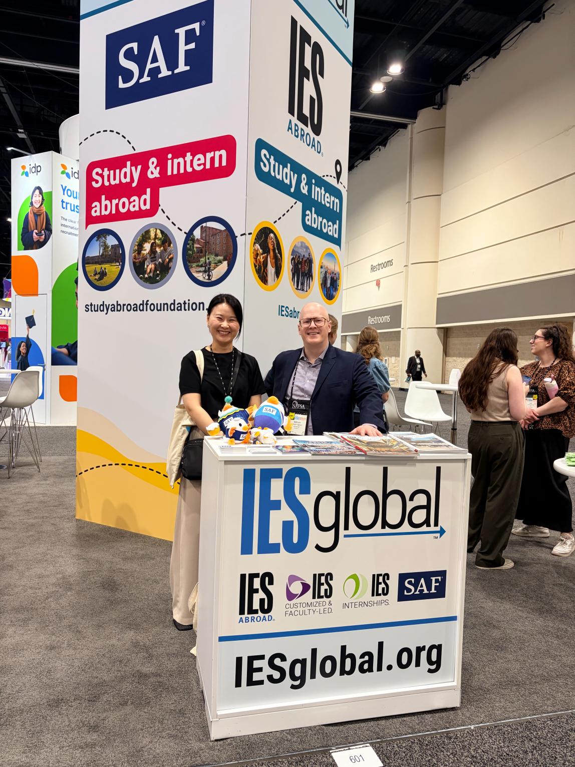 SAF staff at IES Global booth, with the SAF and IES Abroad banners in the background.