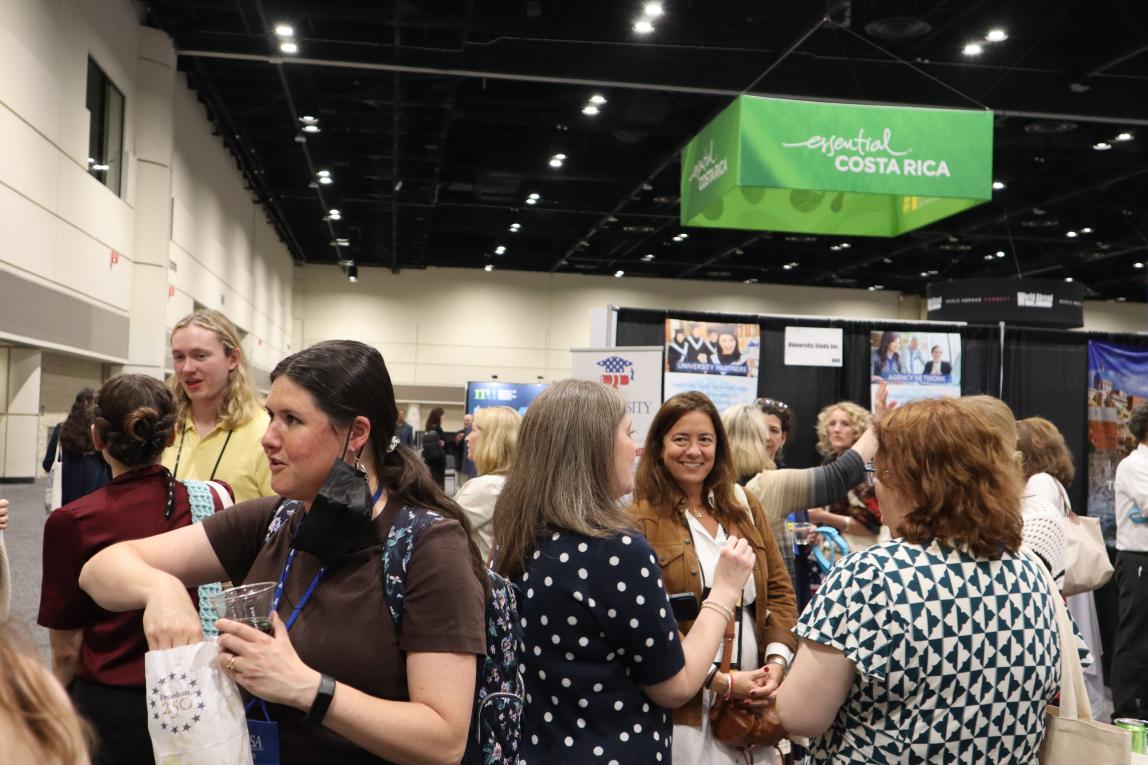 Group of attendees at NAFSA 2026 chatting inside the convention.