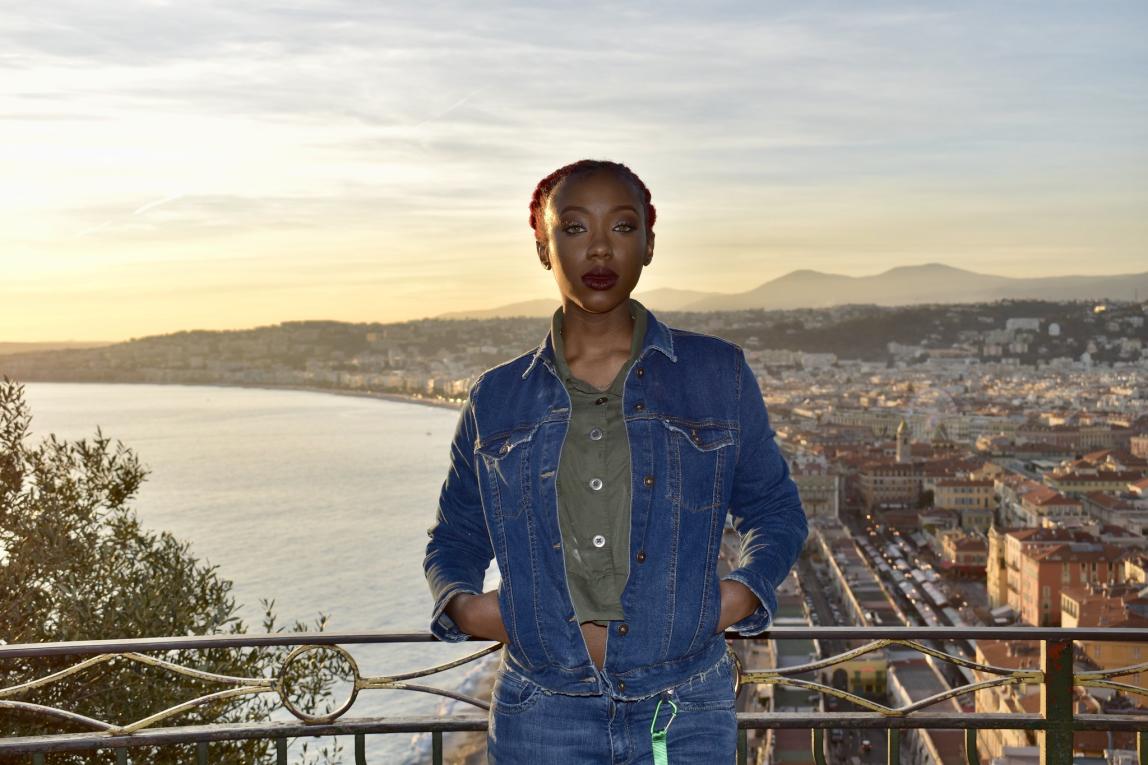 a beauitful sunset photo of a girl in front of a Nice backdrop