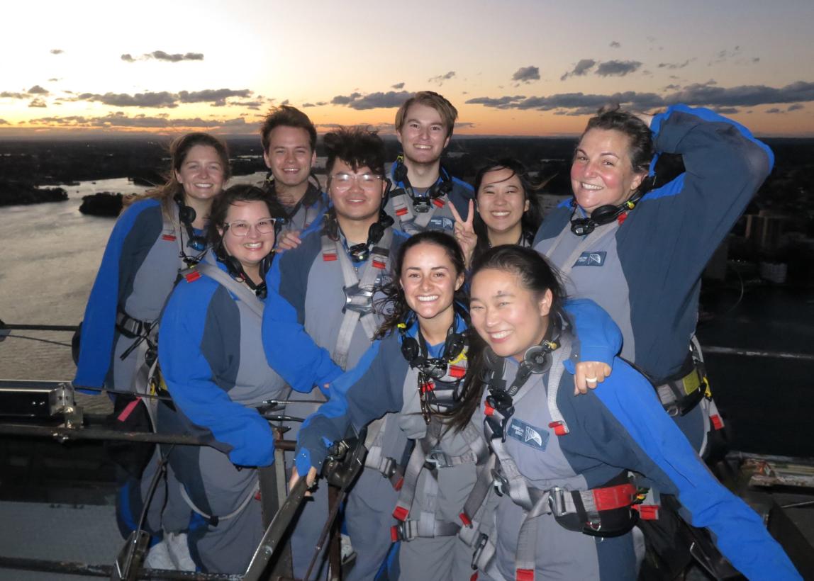 Sydney Center staff posing for a photo with students atop the Sydney Bridge