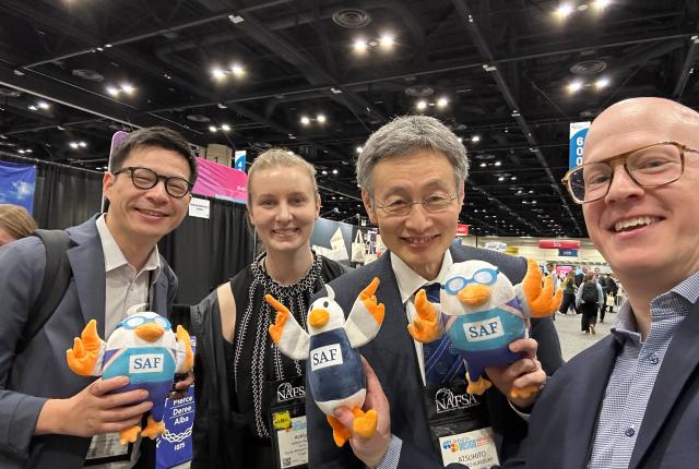SAF staff with university partners at NAFSA 2026, holding up SAFFY dolls.