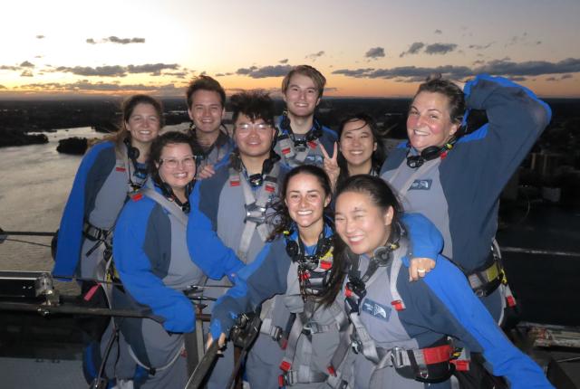 Sydney Center staff posing for a photo with students atop the Sydney Bridge