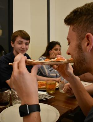 Students eat pizza in Italy
